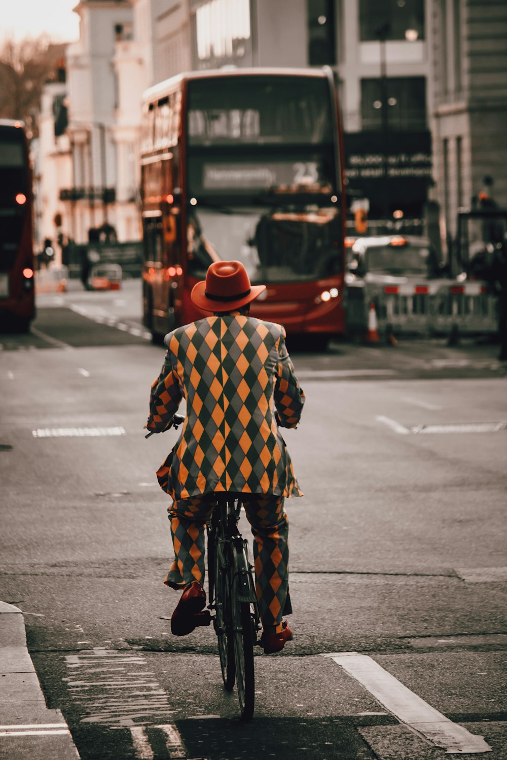 a man riding a bike down a street next to a bus