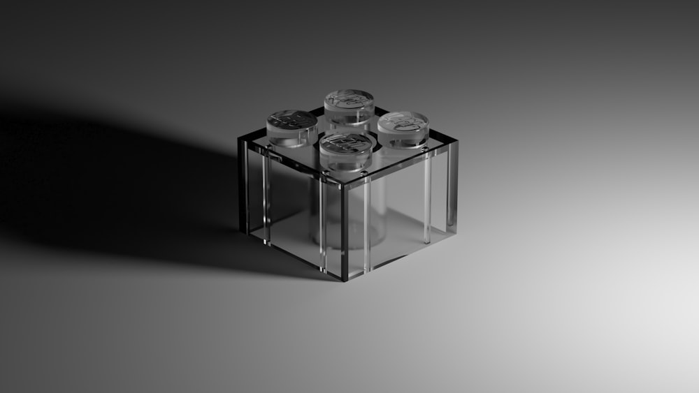 a clear glass vase with four bottles in it