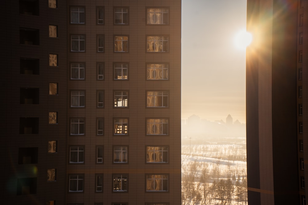 the sun shines through the windows of a tall building