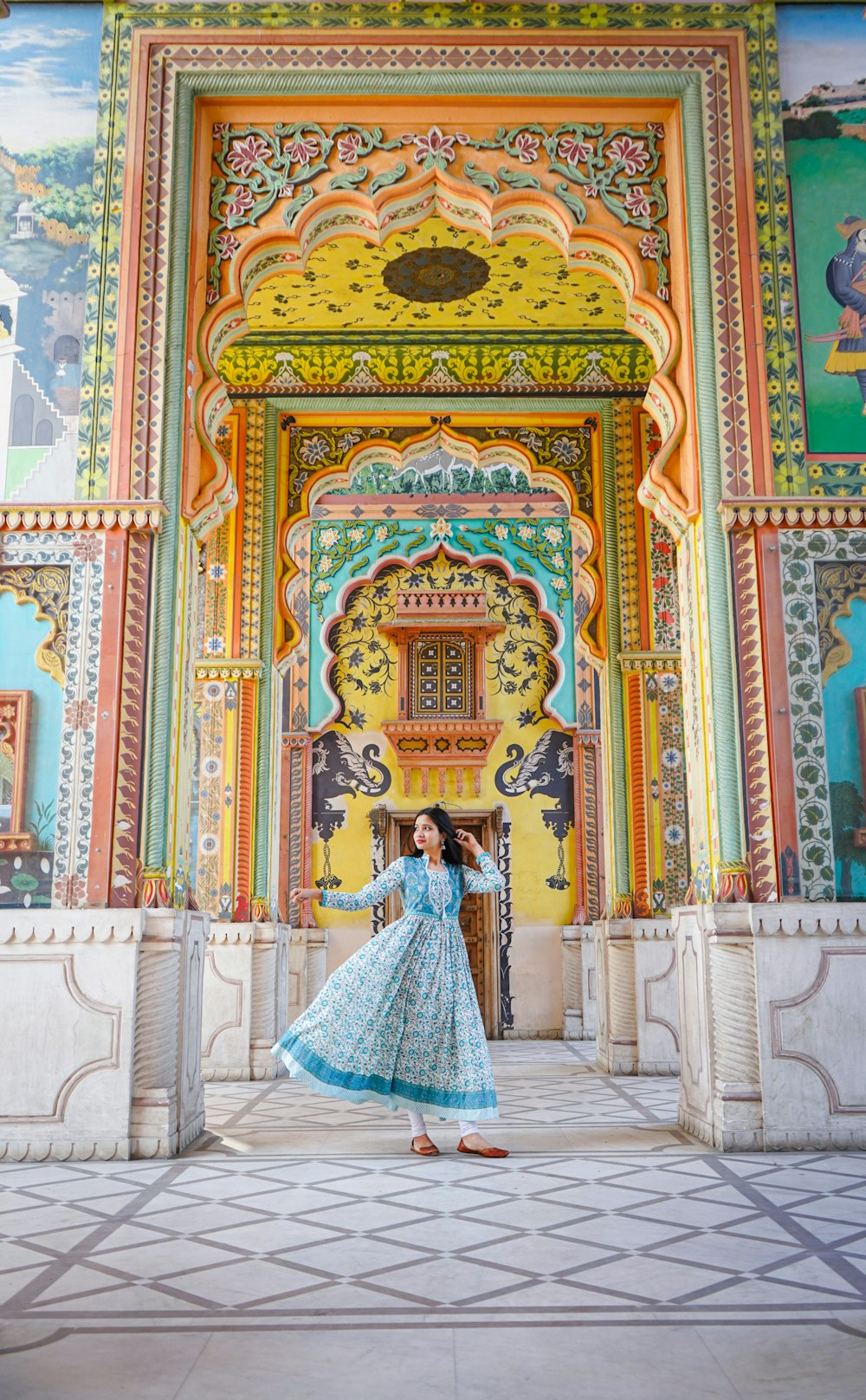 a woman standing in front of a colorful building