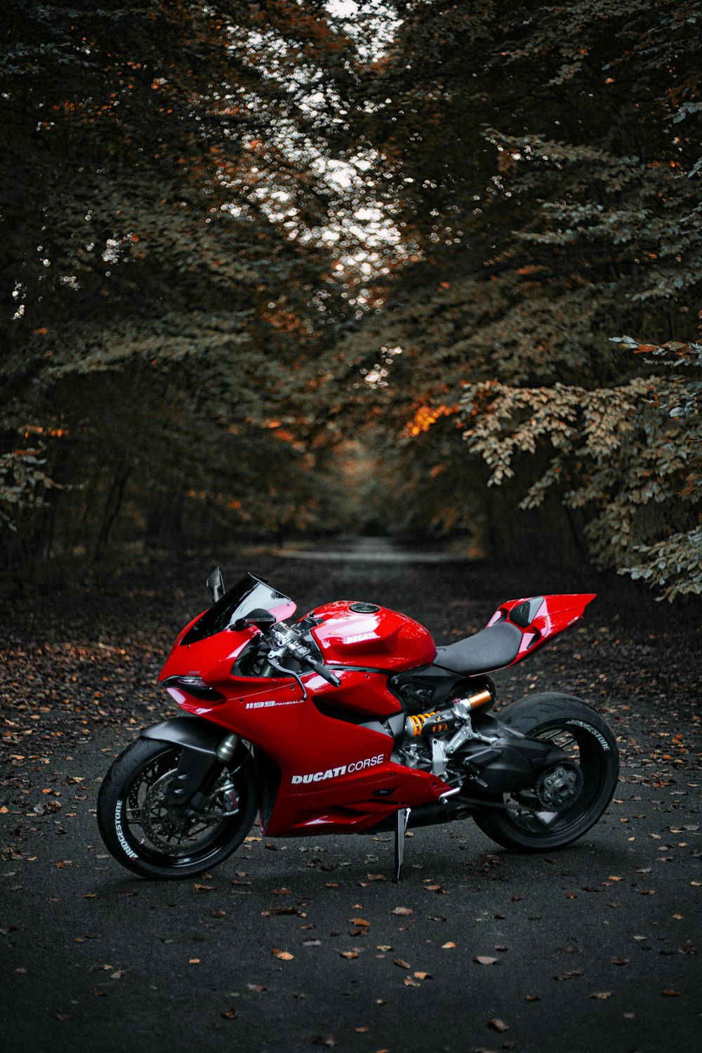 a red motorcycle parked on the side of a road