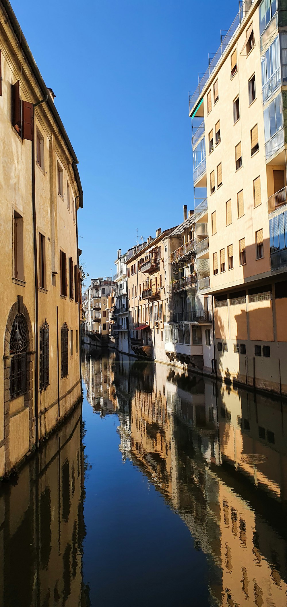 a river running through a city next to tall buildings