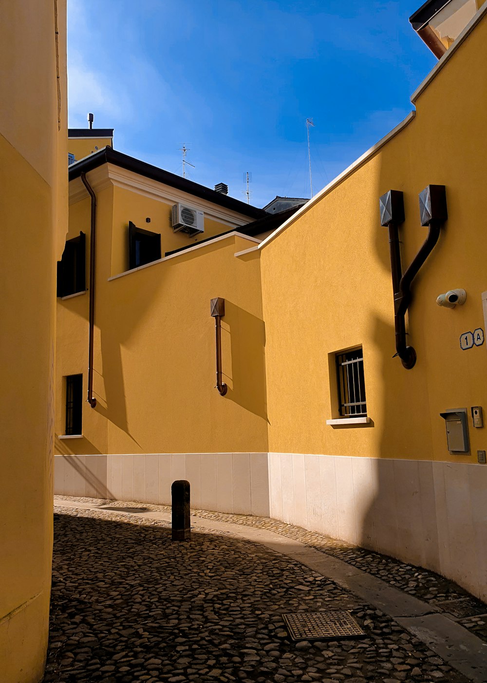 a yellow building with a clock on the side of it