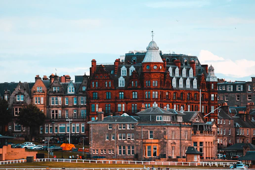 a large red brick building with a clock tower
