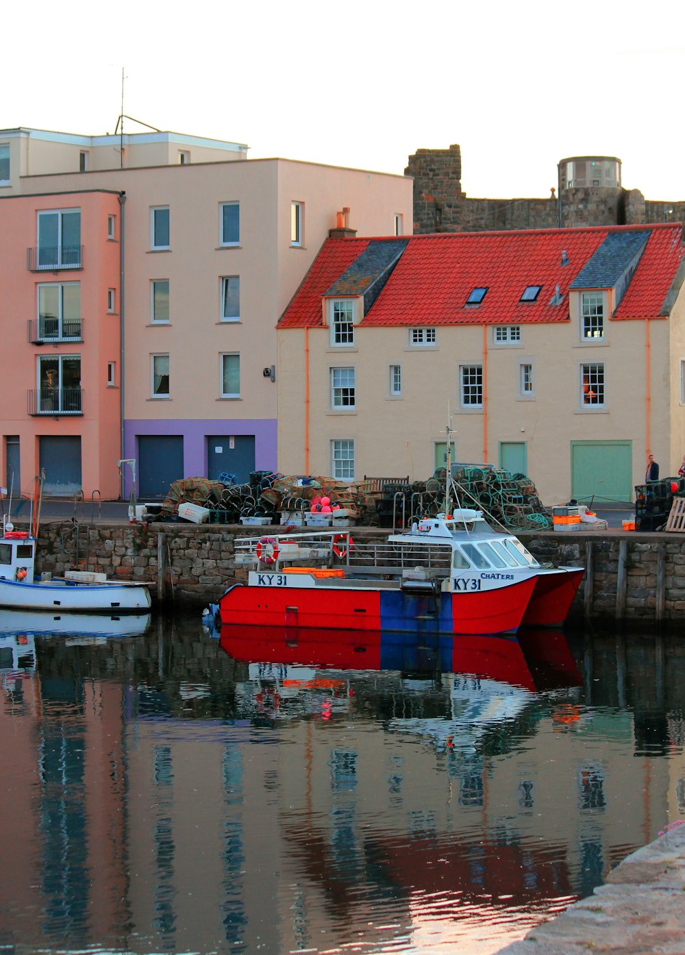 a red and blue boat in a body of water