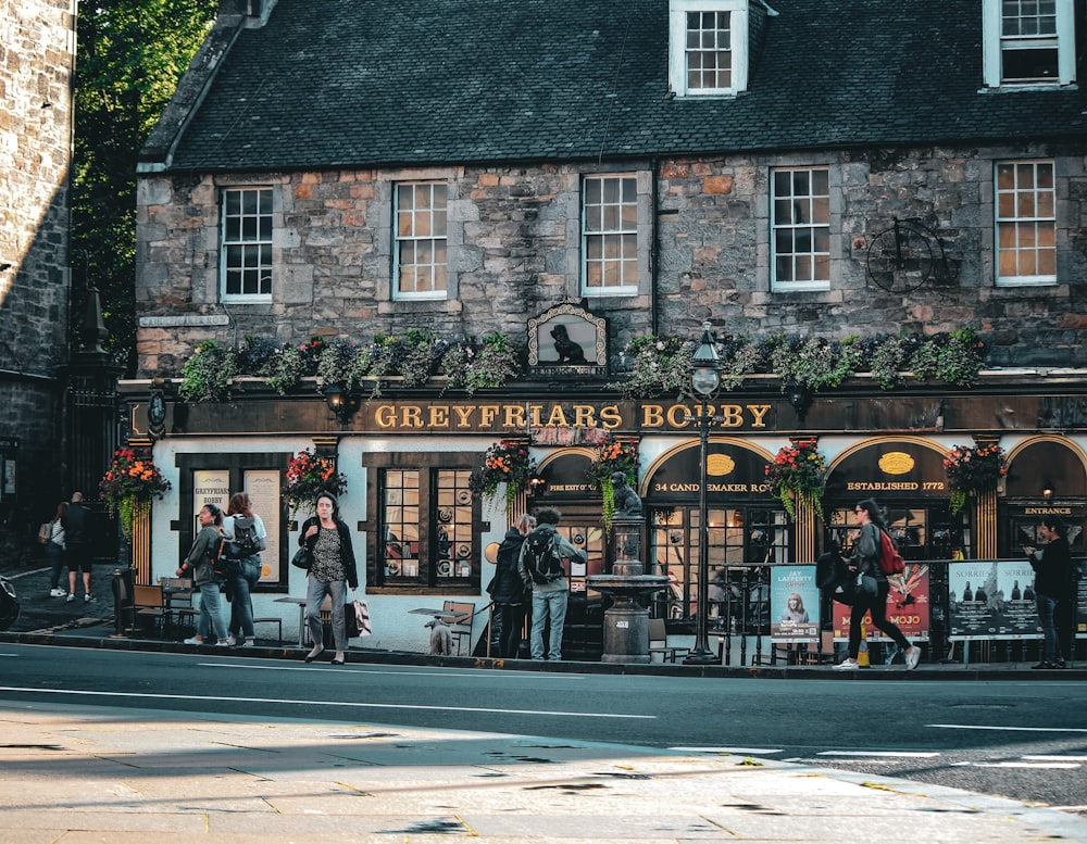 a group of people standing outside of a store