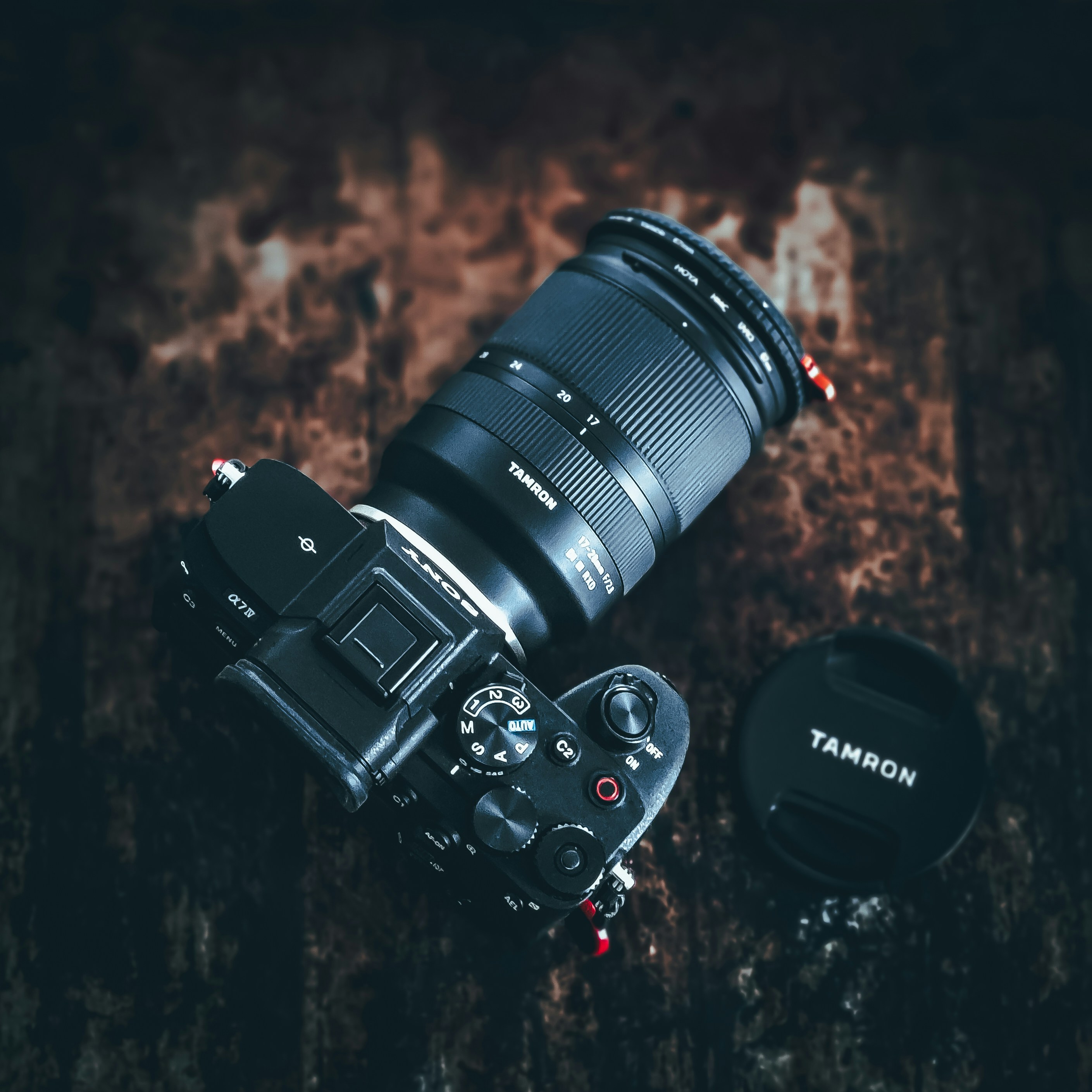 Professional mirrorless camera with lens on dark textured surface
