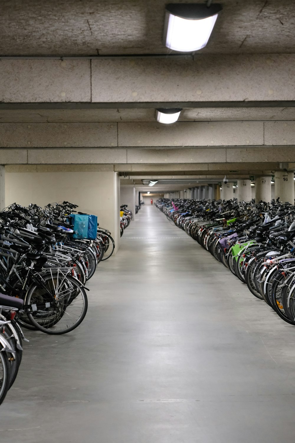 a parking garage filled with lots of bikes