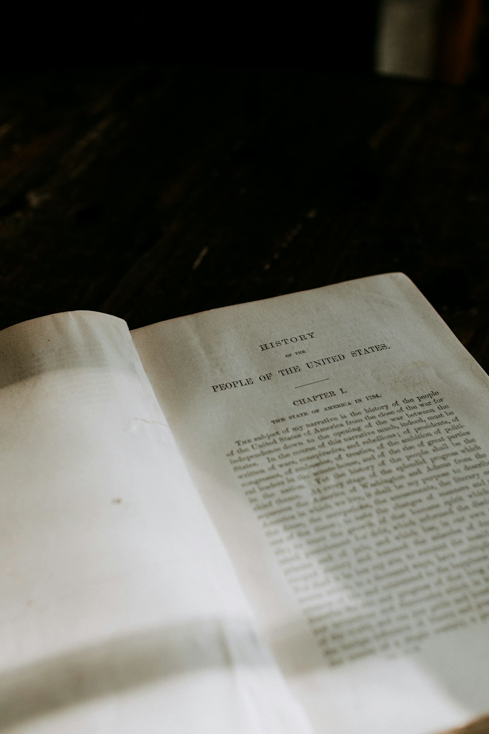 an open book sitting on top of a wooden table