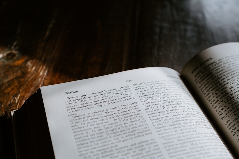 an open book sitting on top of a wooden table