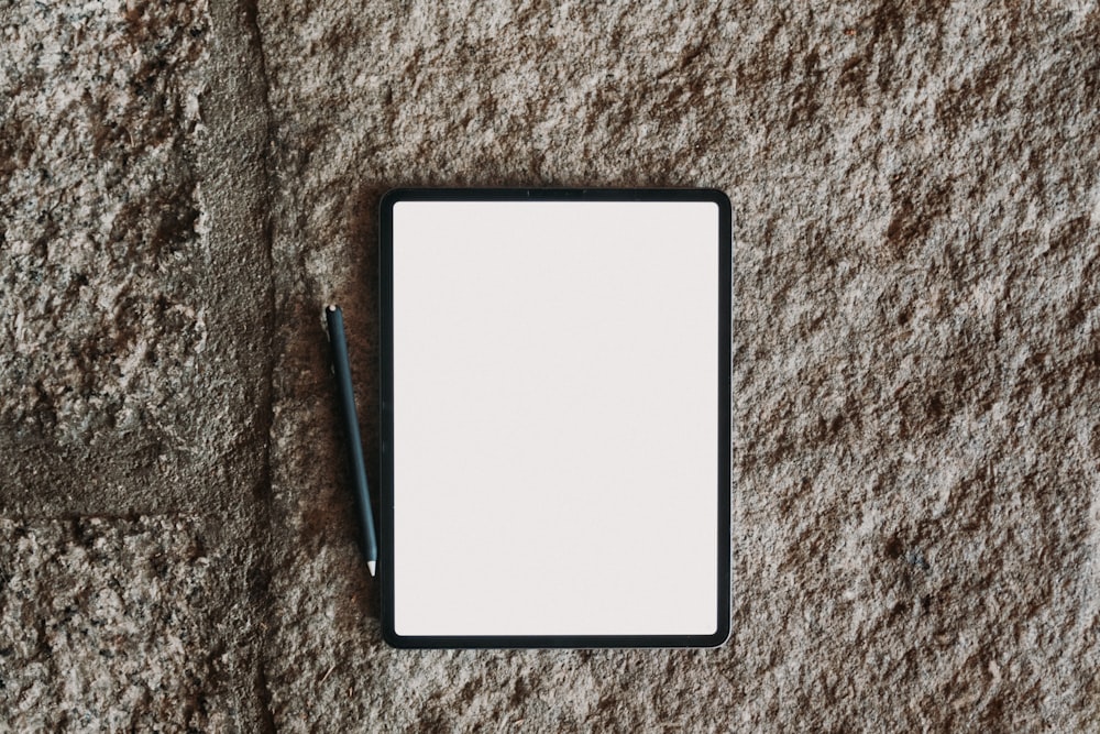 a notepad with a pen on top of it