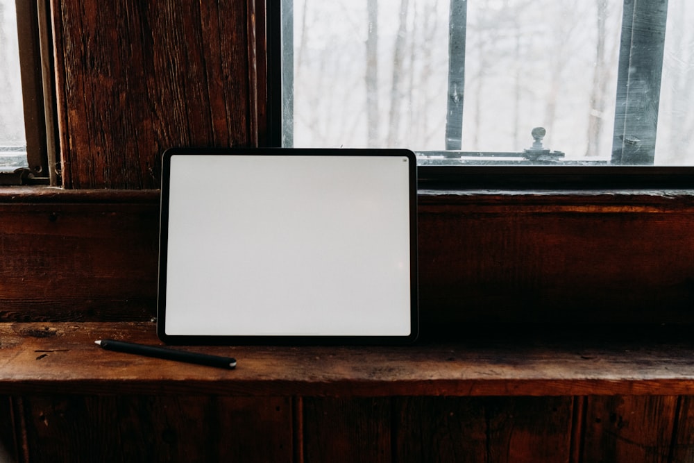 a white board sitting on top of a wooden shelf