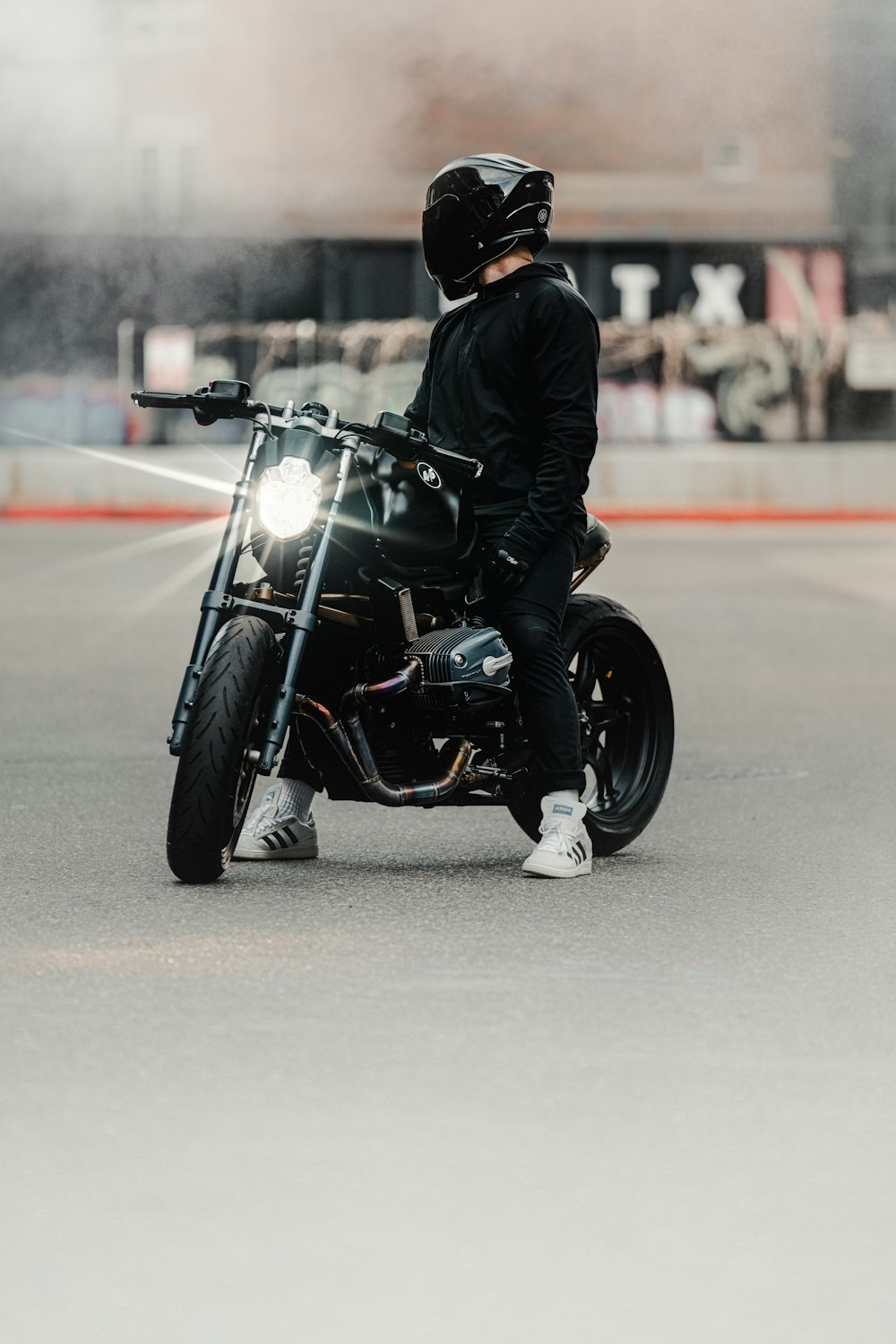 a man riding a motorcycle down a street