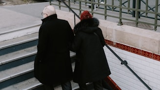 a couple of people that are standing on some stairs