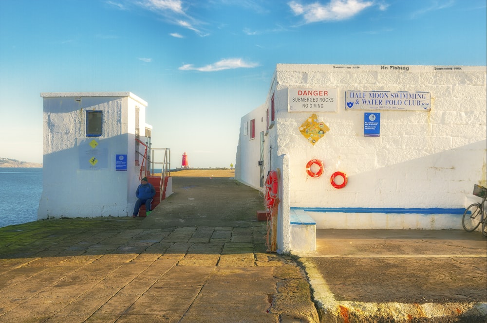 a white building next to a body of water