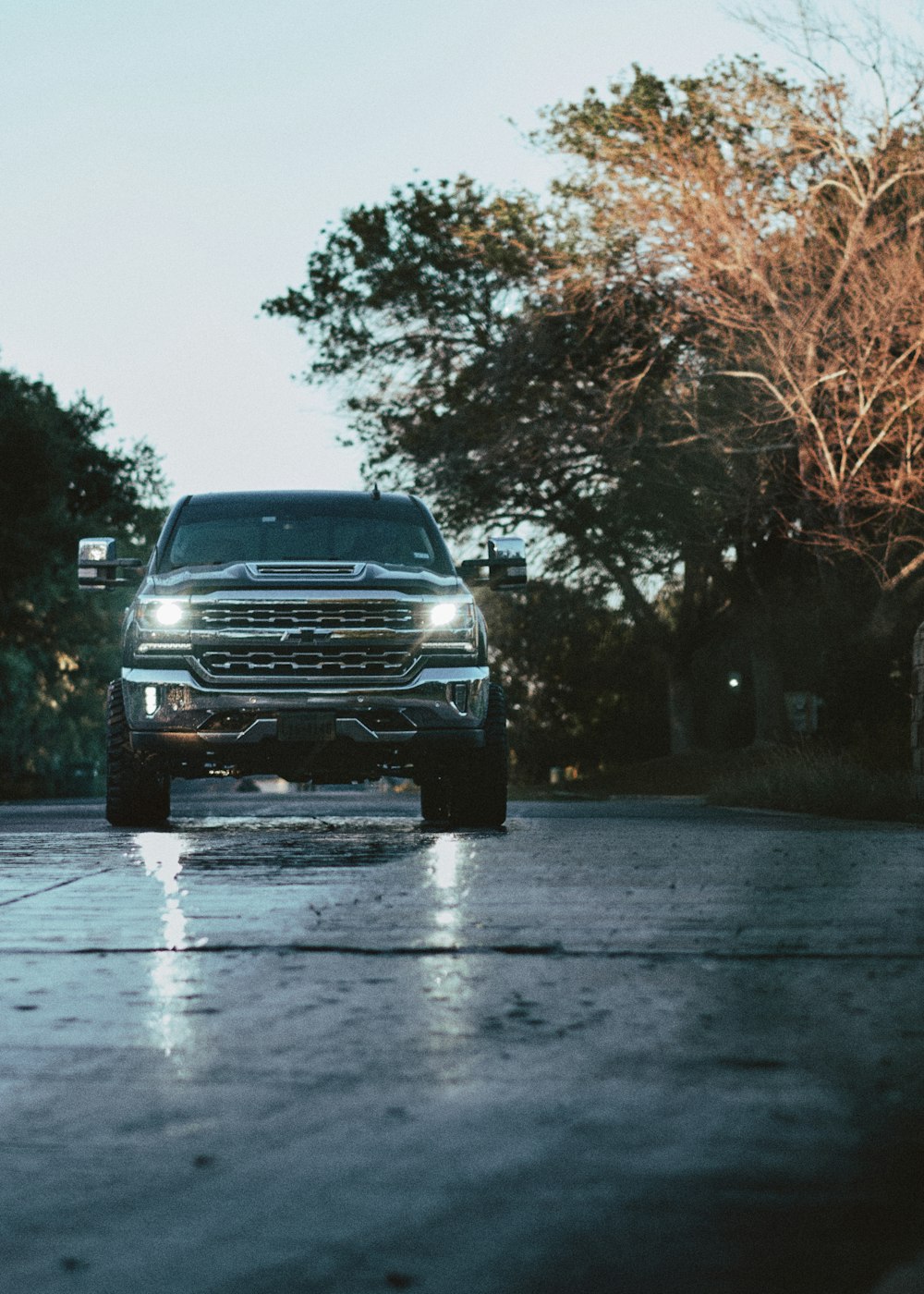 a truck is driving down a wet road