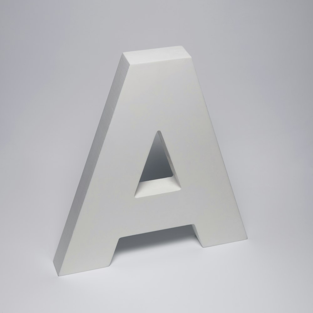 a white letter sitting on top of a table