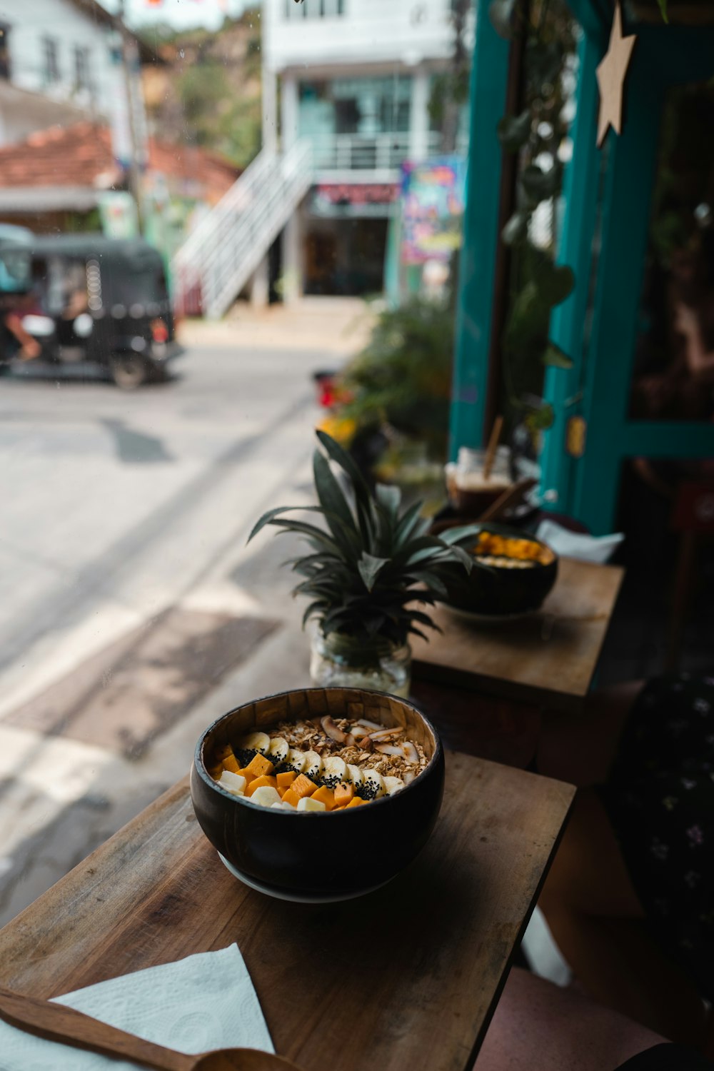 a bowl of food sitting on top of a wooden table