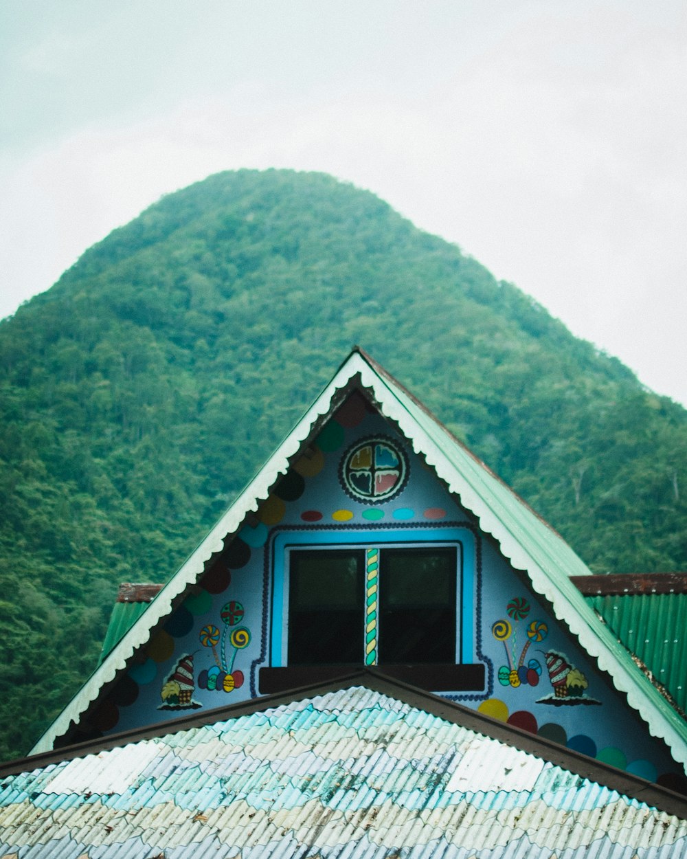 a colorful building with a mountain in the background