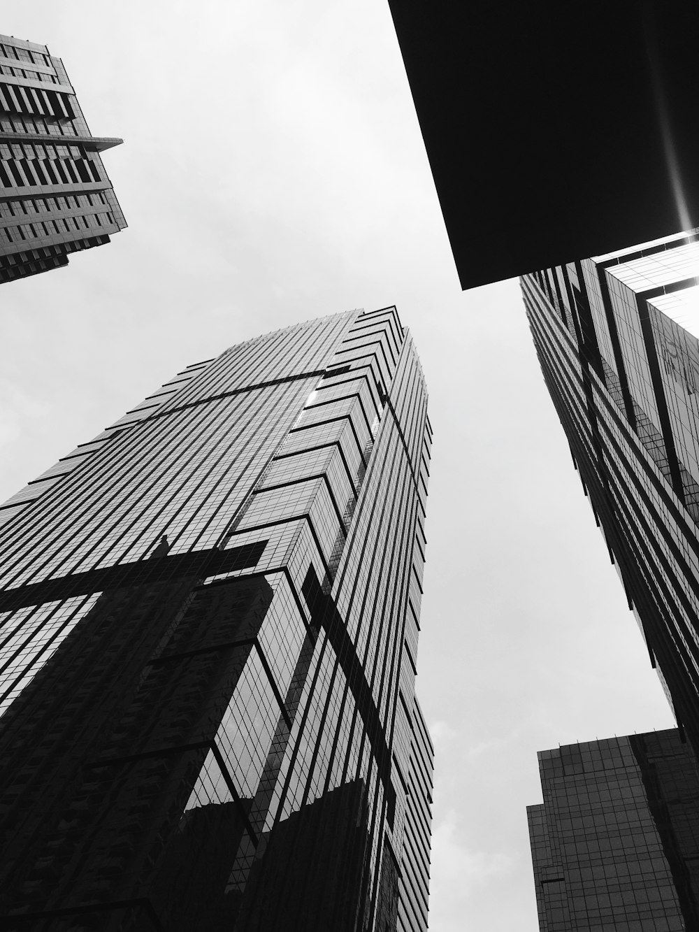 a black and white photo of tall buildings