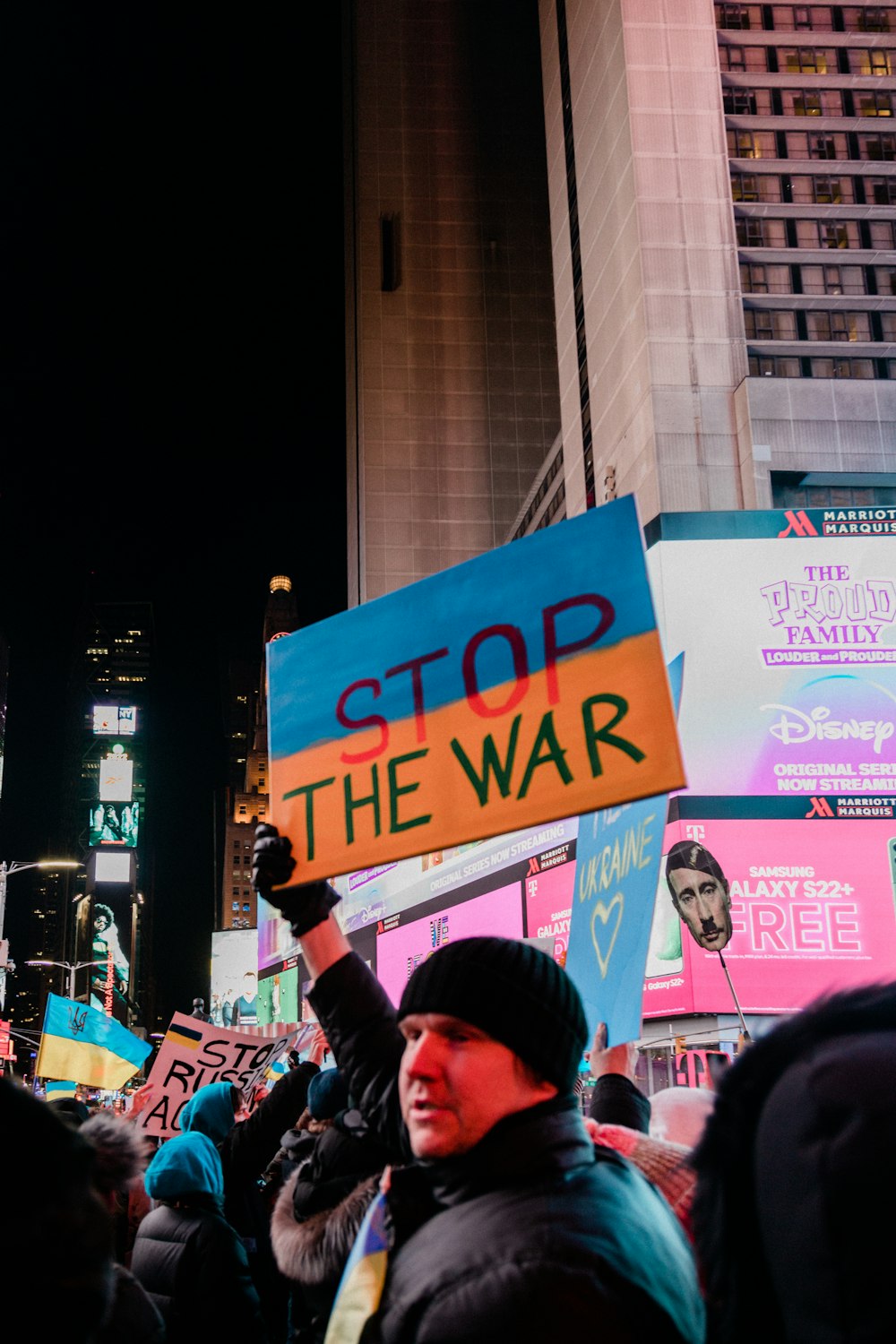 a crowd of people holding up signs in the street