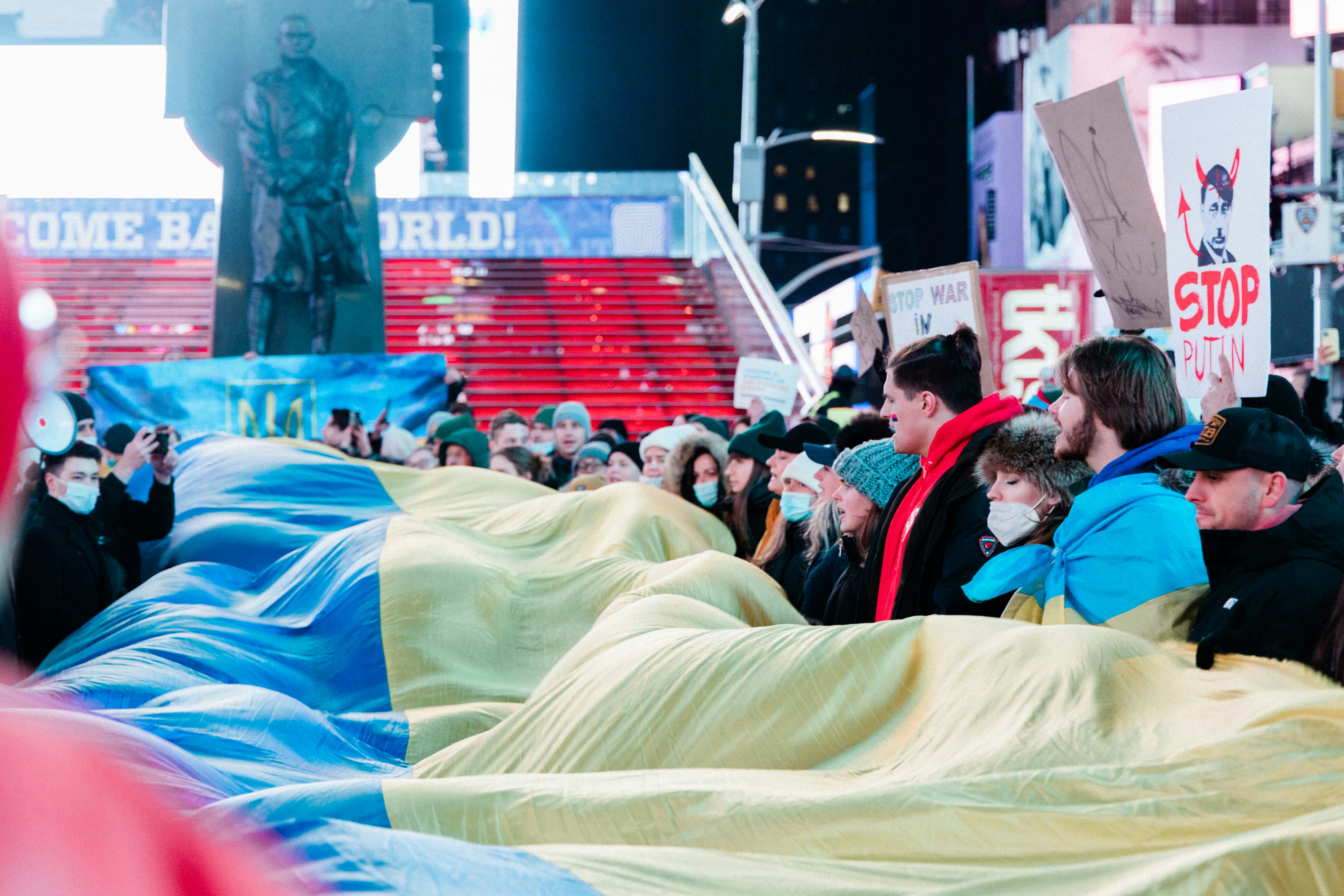 a crowd of people standing around a giant sleeping bag