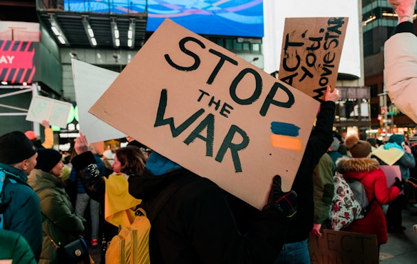 a group of people holding up signs in a crowd