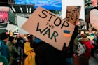 a group of people holding up signs in a crowd