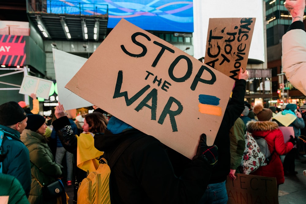 a group of people holding up signs in a crowd