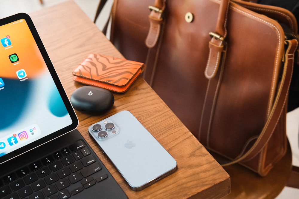 a laptop computer sitting on top of a wooden table