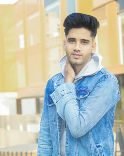 Stylish young man showing off a sharp haircut and perfectly trimmed beard in natural light