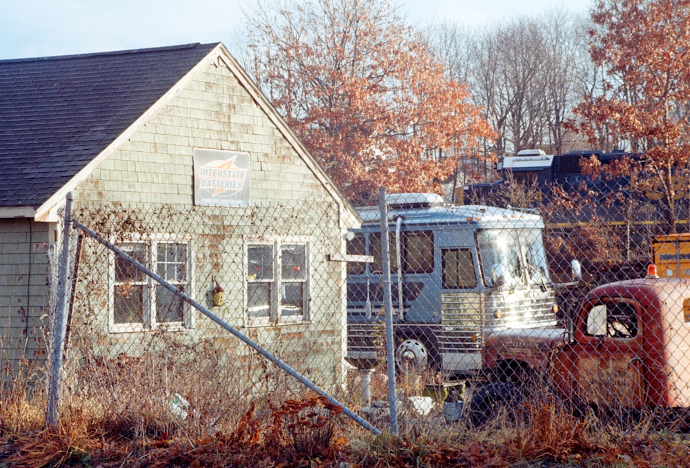 an old truck is parked in front of a house
