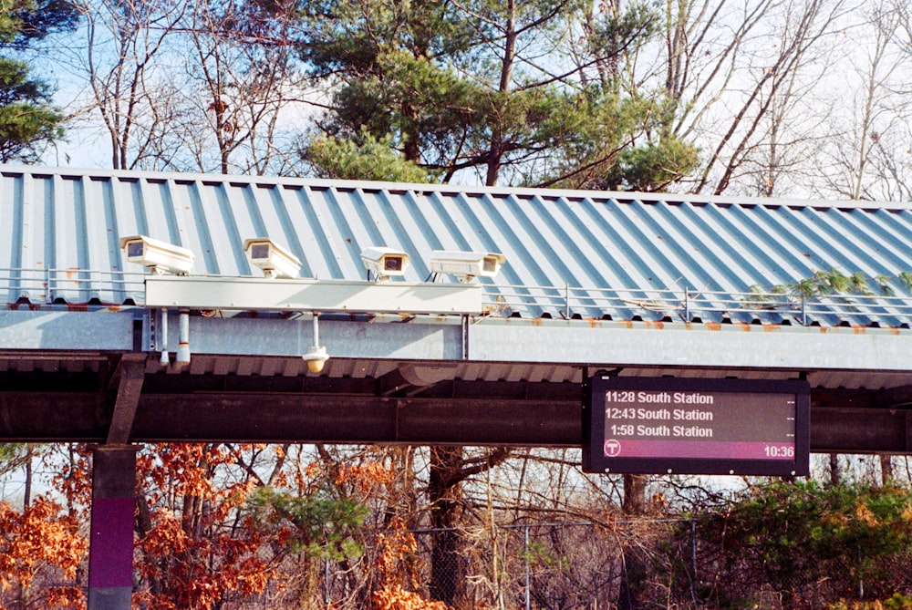 a train bridge with a blue metal roof