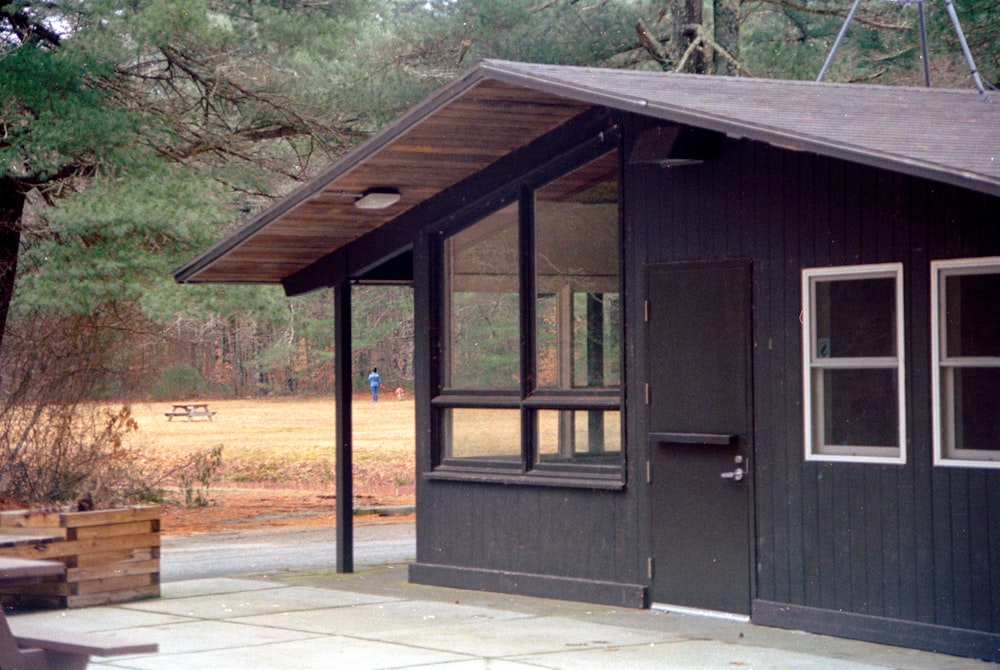 a small cabin with a picnic table and benches