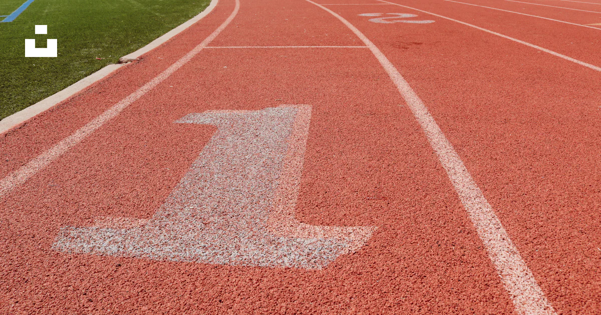 A red track with a white arrow painted on it photo – Free Running track ...