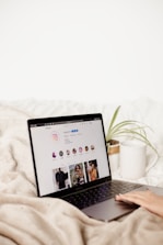 a laptop computer sitting on top of a bed
