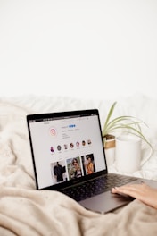 a laptop computer sitting on top of a bed