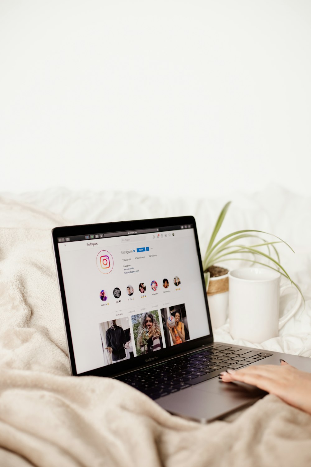 a laptop computer sitting on top of a bed