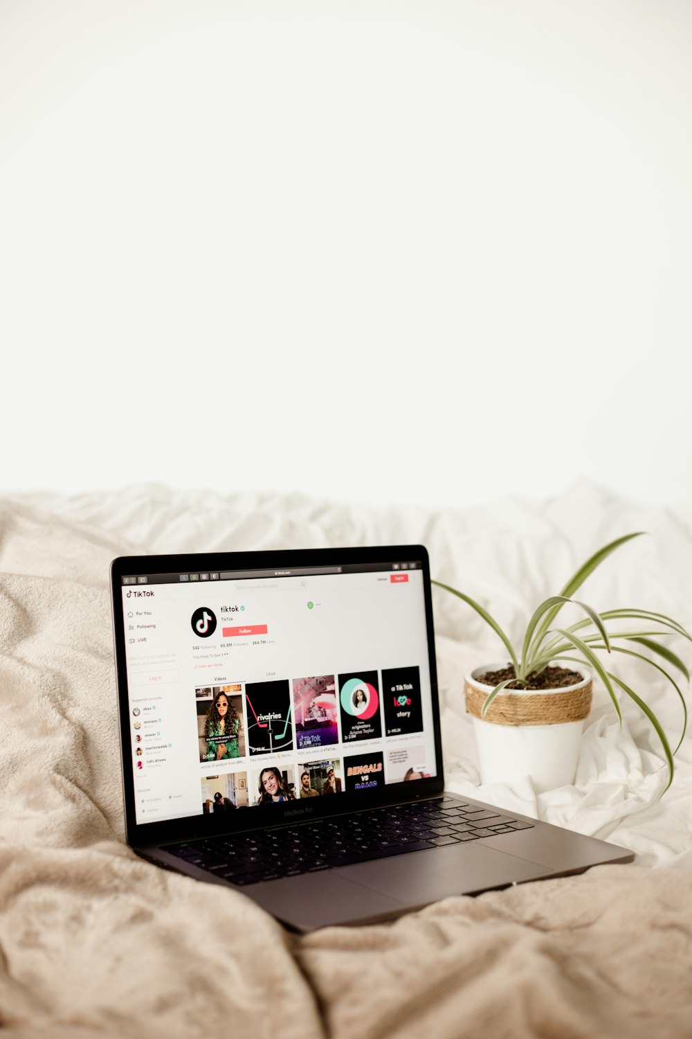 a laptop computer sitting on top of a bed