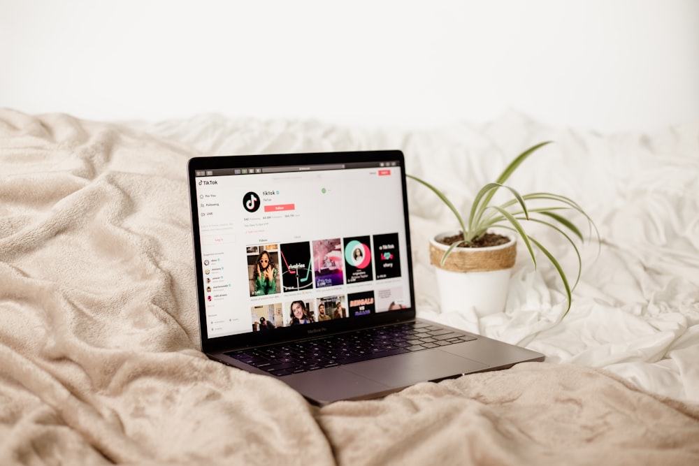 a laptop computer sitting on top of a bed