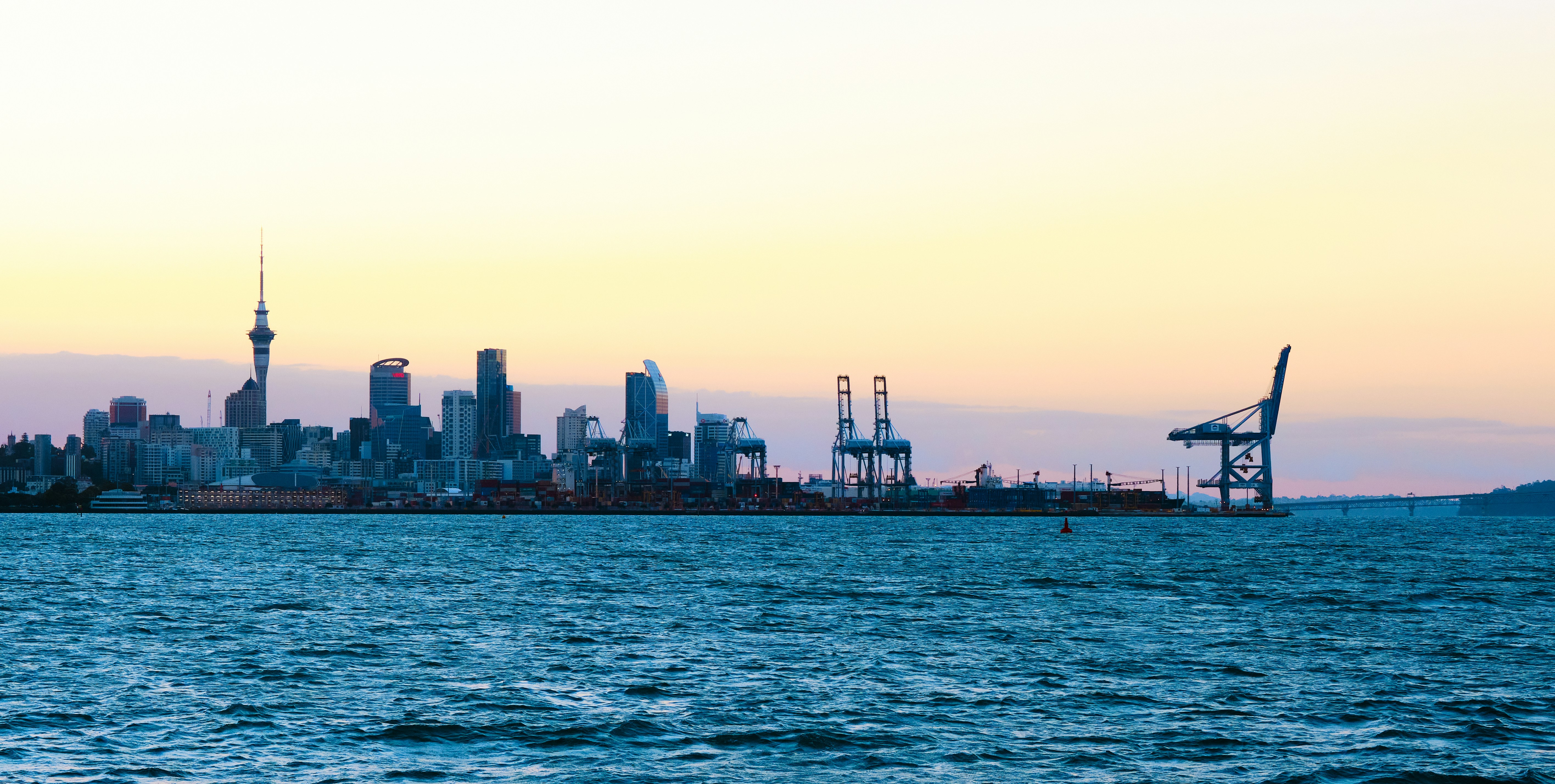 a large body of water with a city in the background
