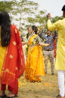 a group of people throwing confetti on each other