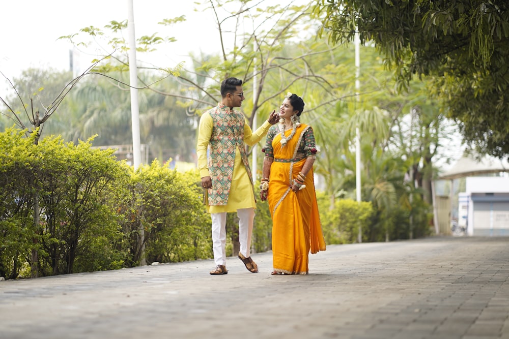 a man and a woman walking down a sidewalk