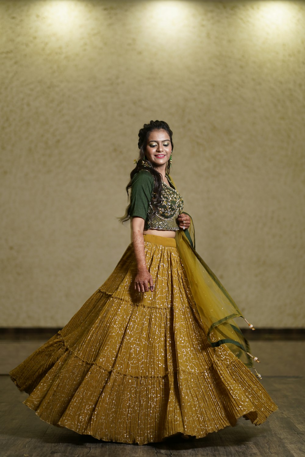 a woman in a yellow and green lehenga