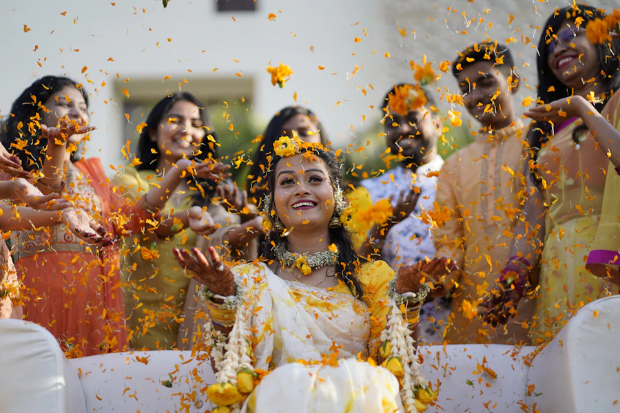 Women laughing as flower petals fall around them