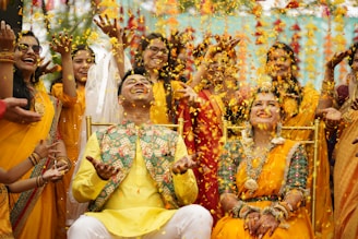 a group of people are throwing confetti in the air