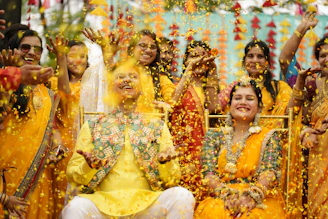 a group of people dressed in yellow and orange