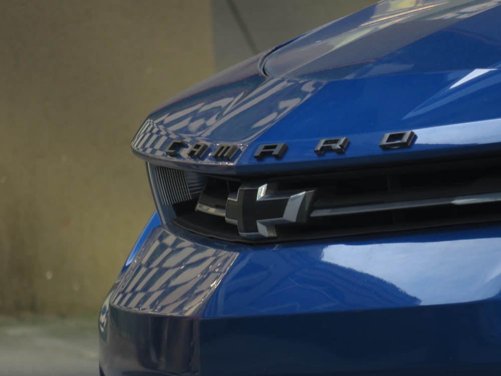 a close up of the front of a blue car