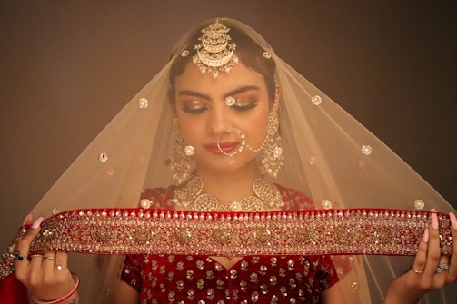 a woman wearing a veil and holding a piece of cloth