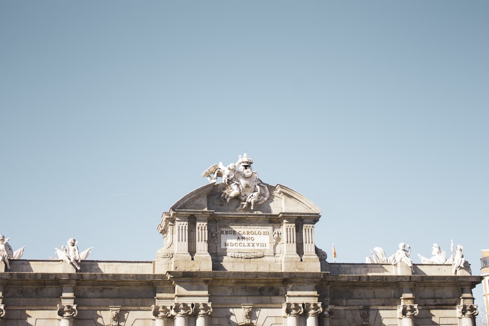 a large building with statues on top of it